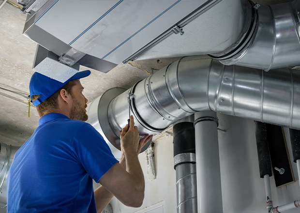 man checking duct